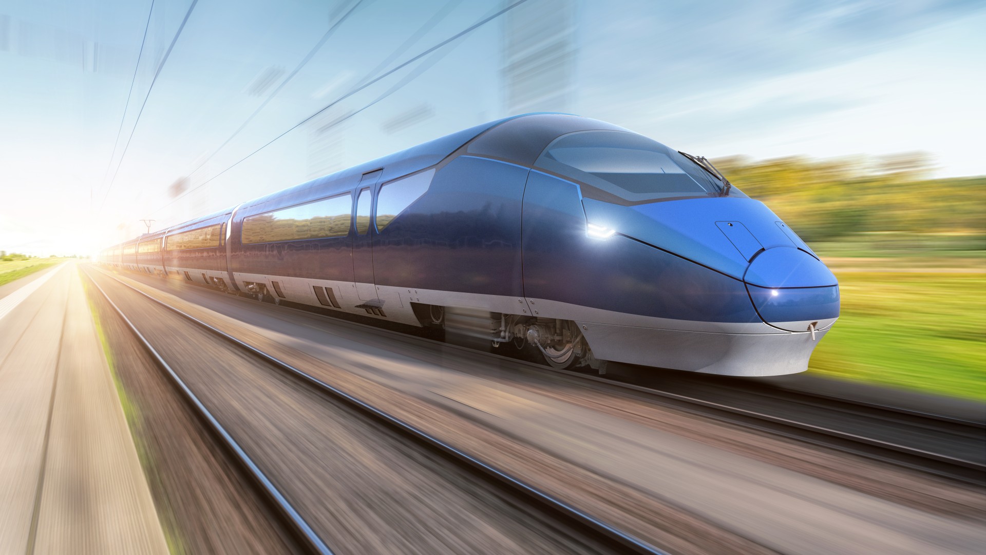 High-speed blue train moving on railway tracks.