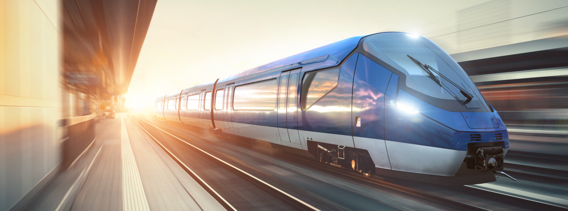 Modern blue train speeding on railway tracks.