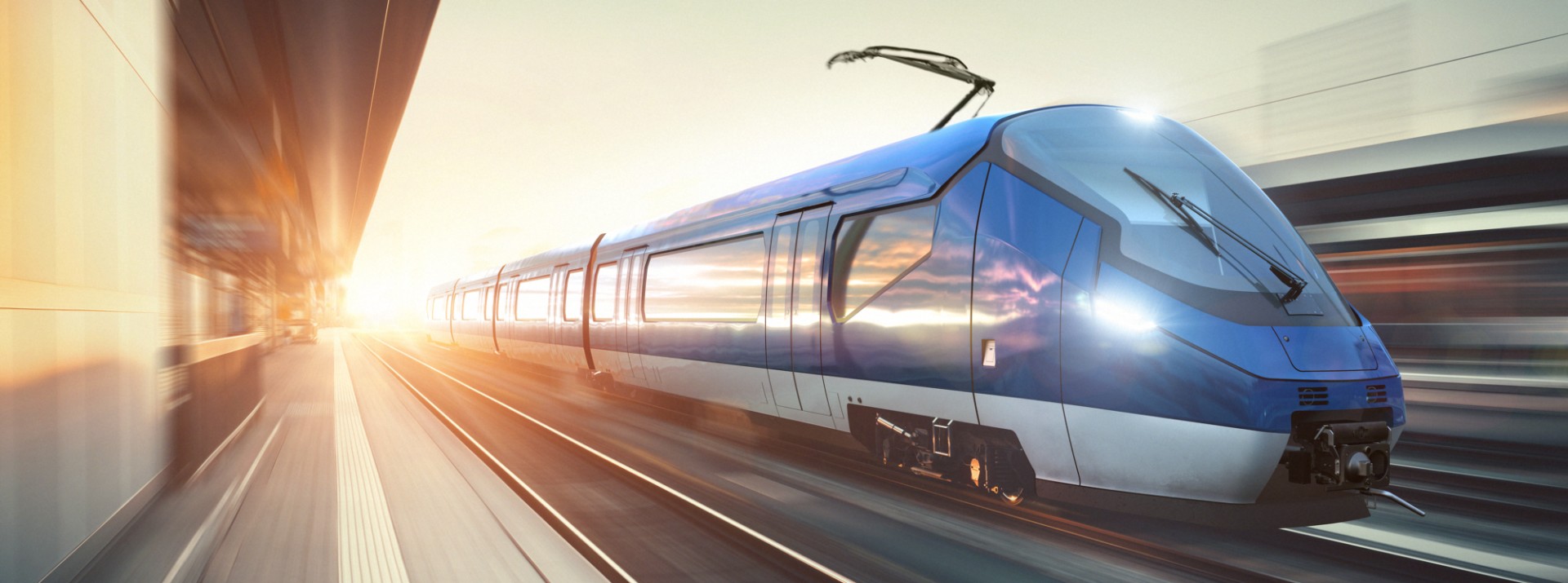 Fast-moving blue train on urban tracks.
