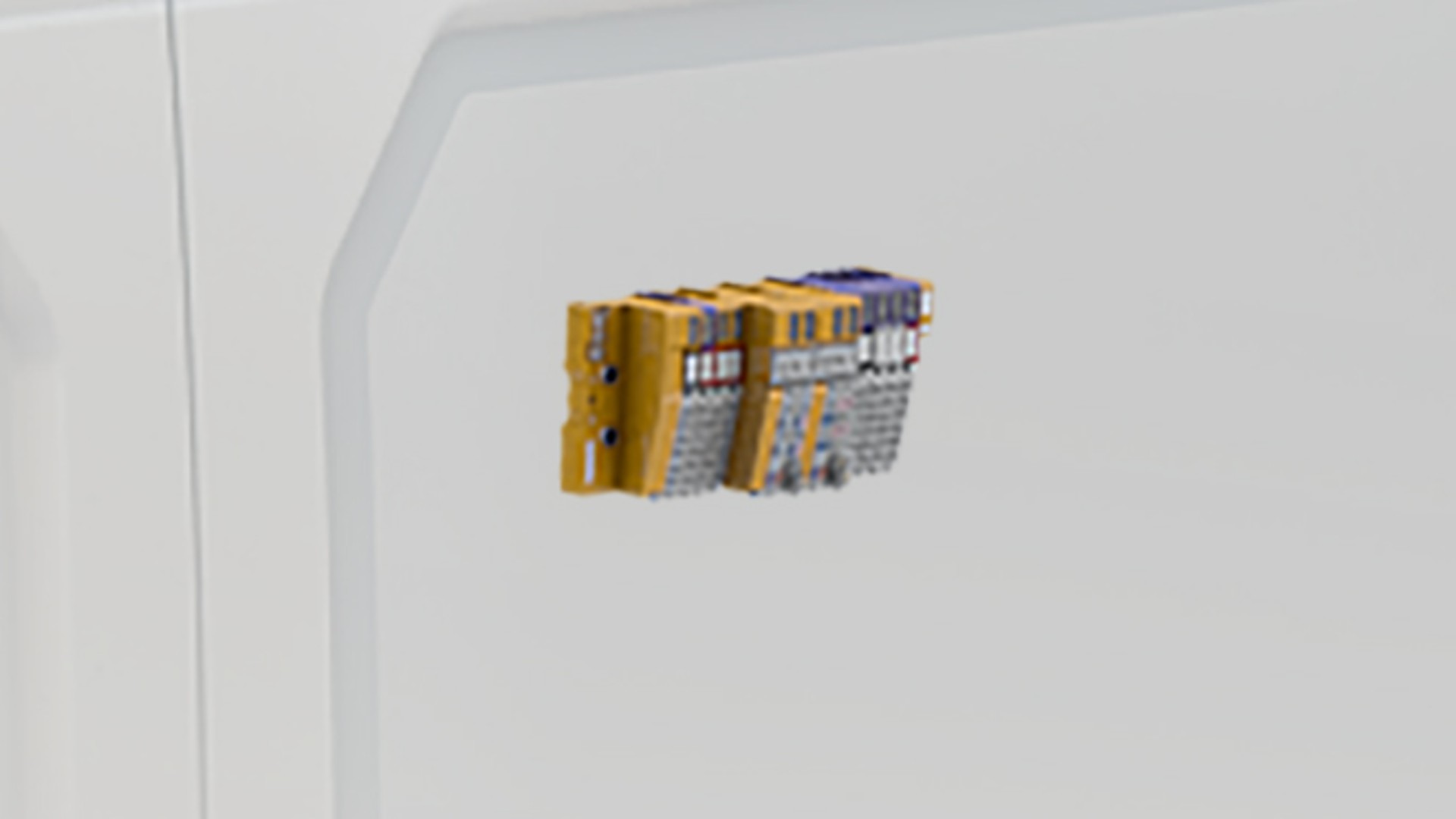 Electronic control unit mounted on white panel.
