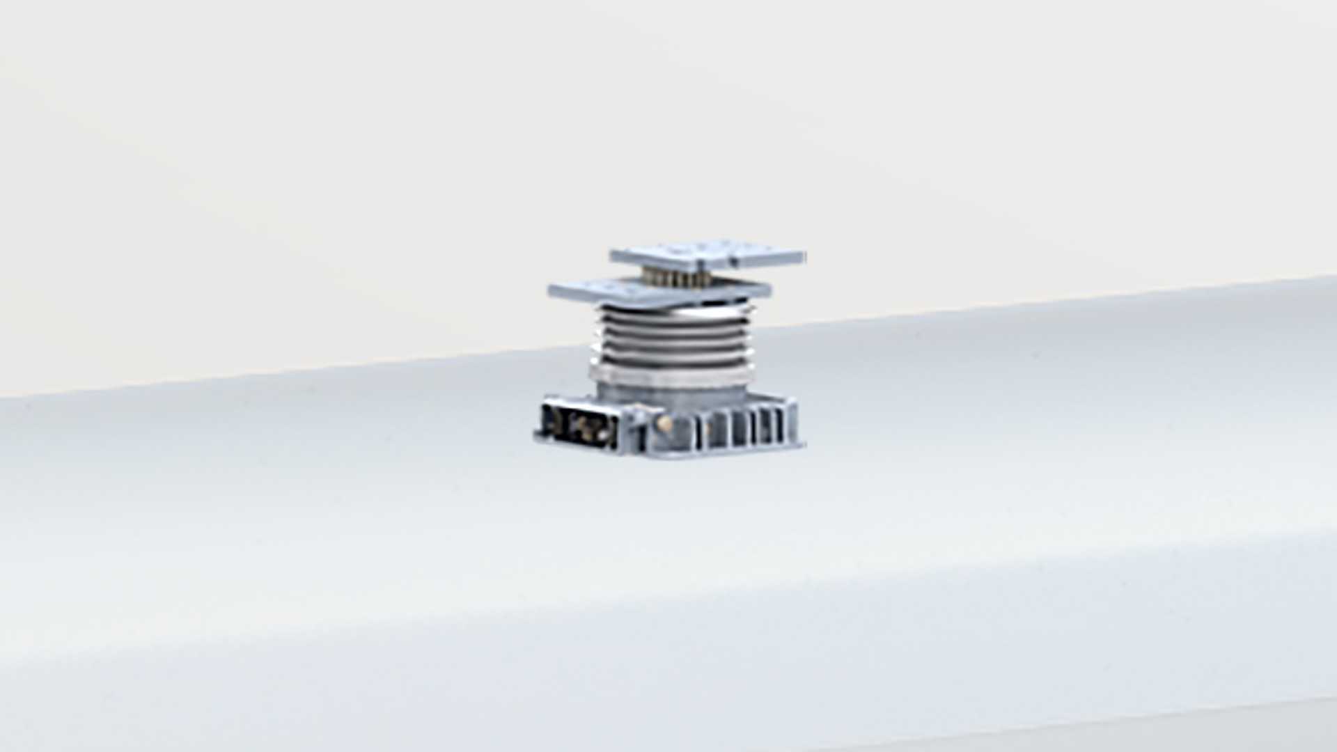 Industrial component on a white surface.