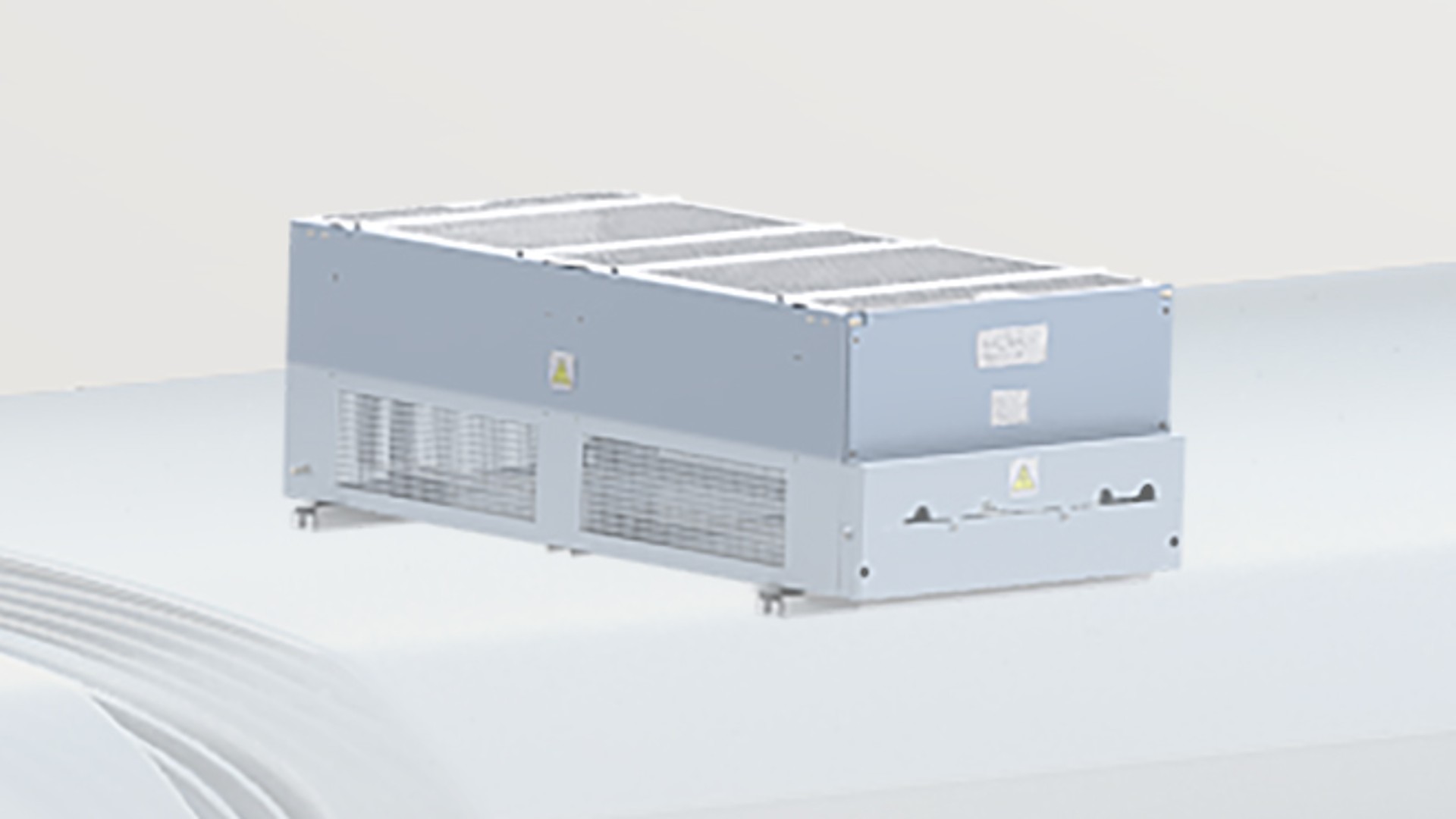 Industrial cooling unit on a white surface.
