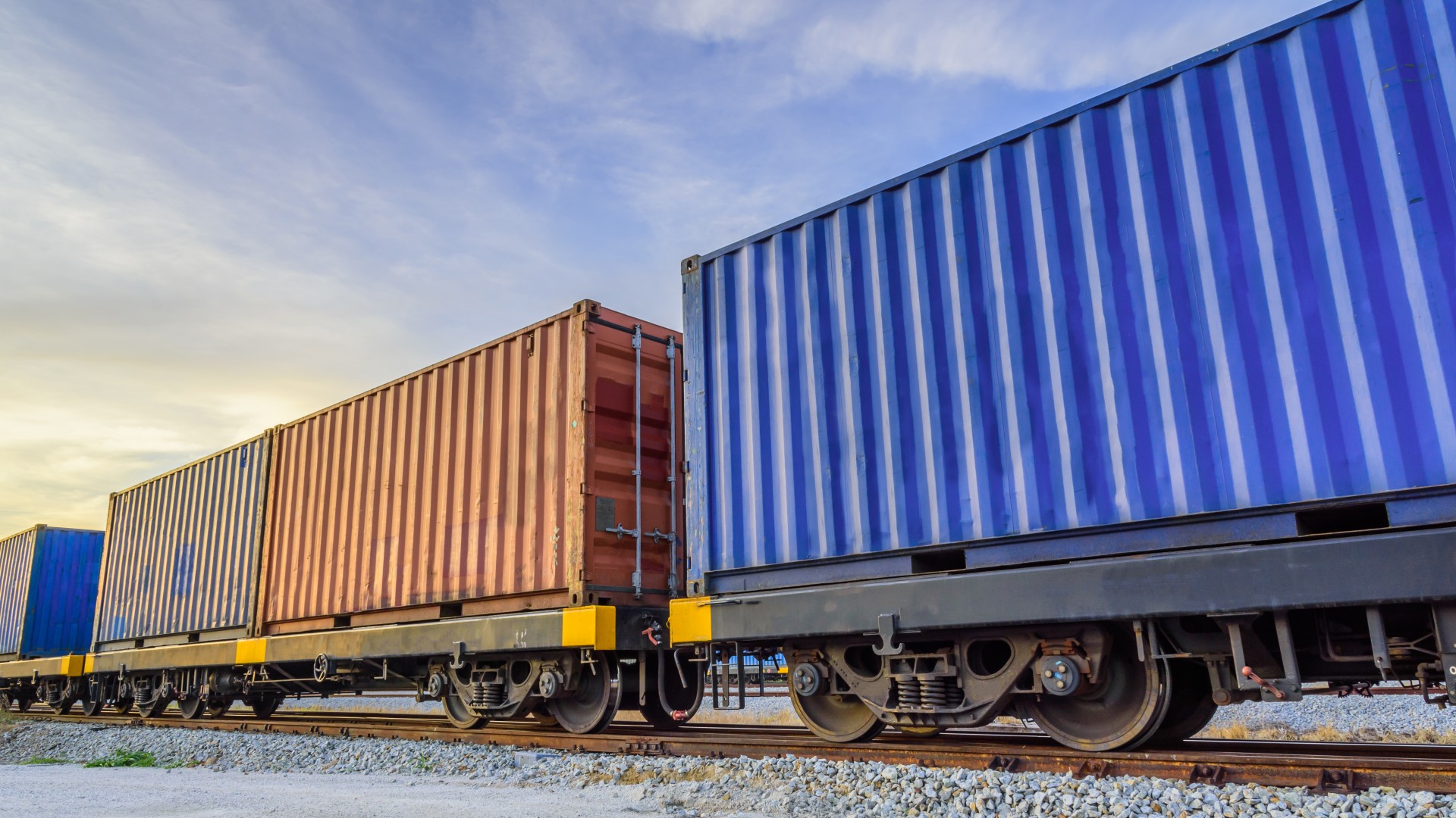 Freight train carrying blue shipping containers