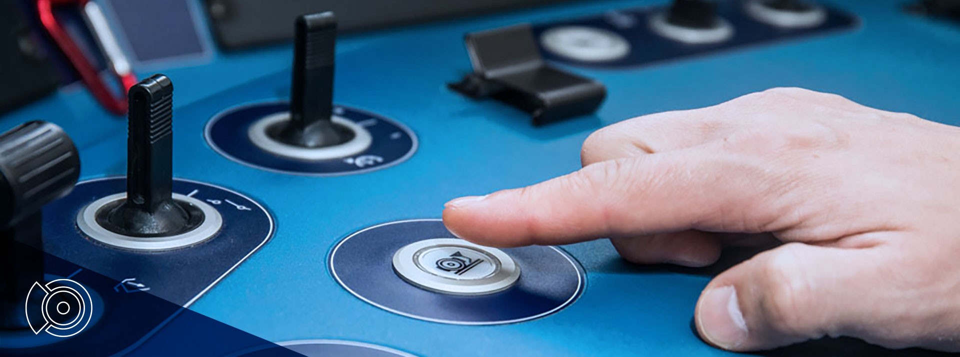 Hand pressing a button on control panel.