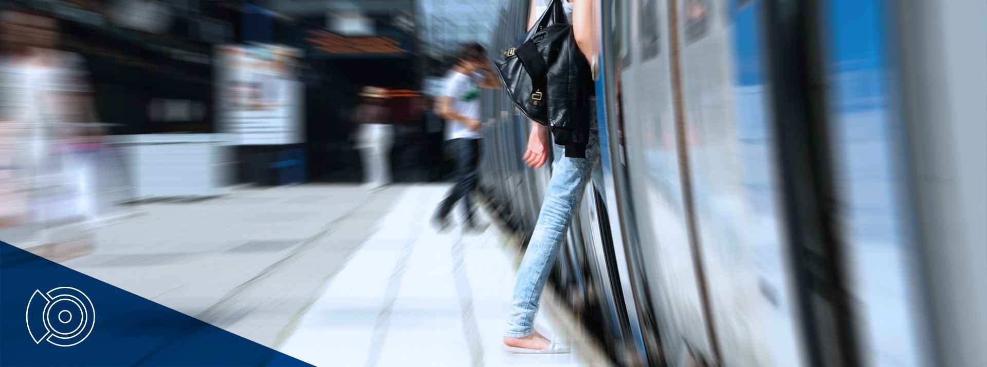 Blurred image of people near train station.