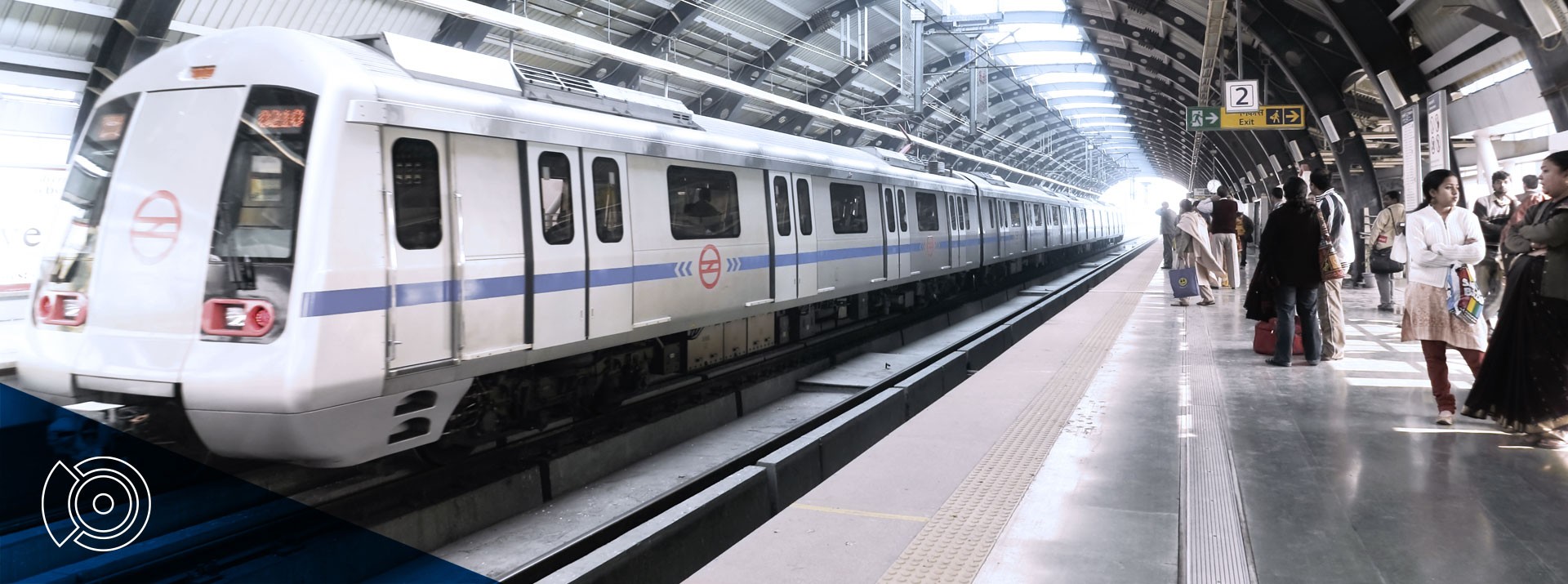 Modern metro train at bustling urban station.