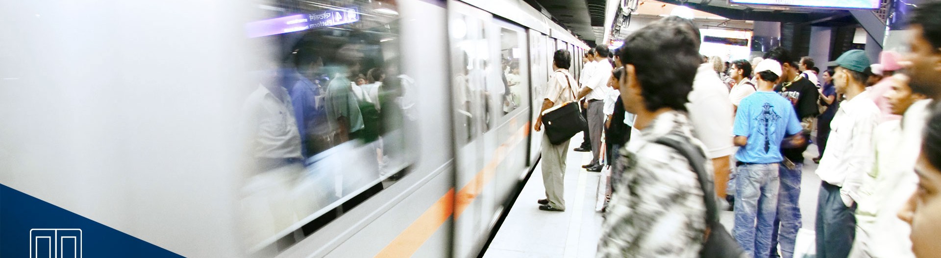Crowded subway platform with approaching train.