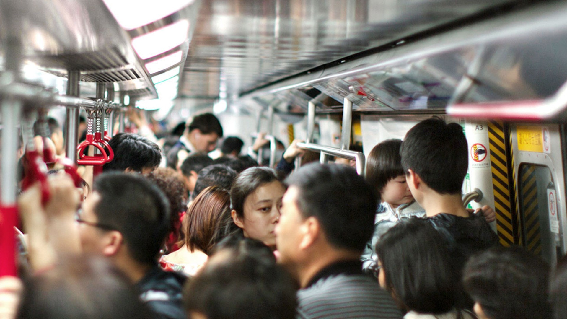 Crowded subway train with diverse passengers.