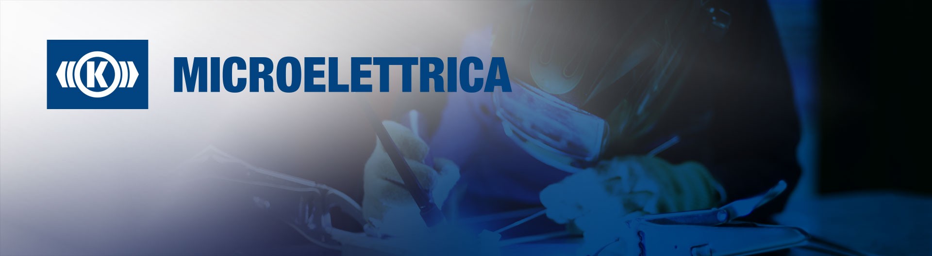 Welder working on microelectronic components in blue