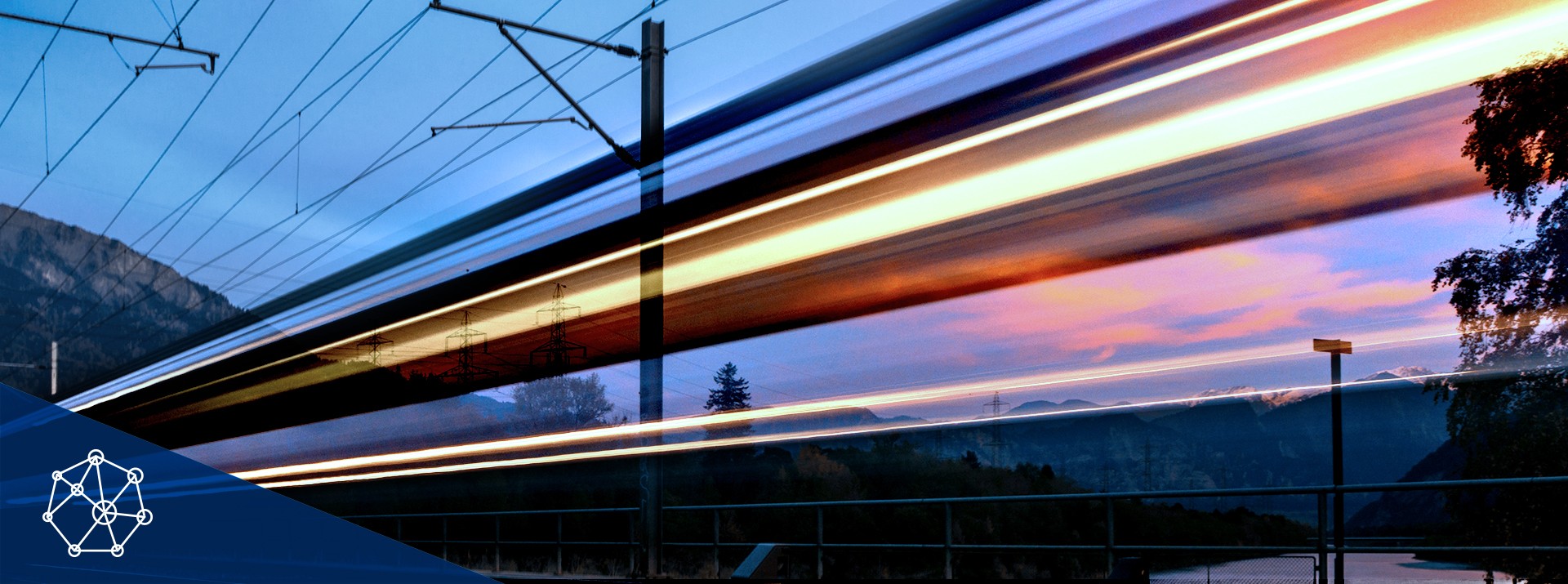Train speeding along tracks at sunset.