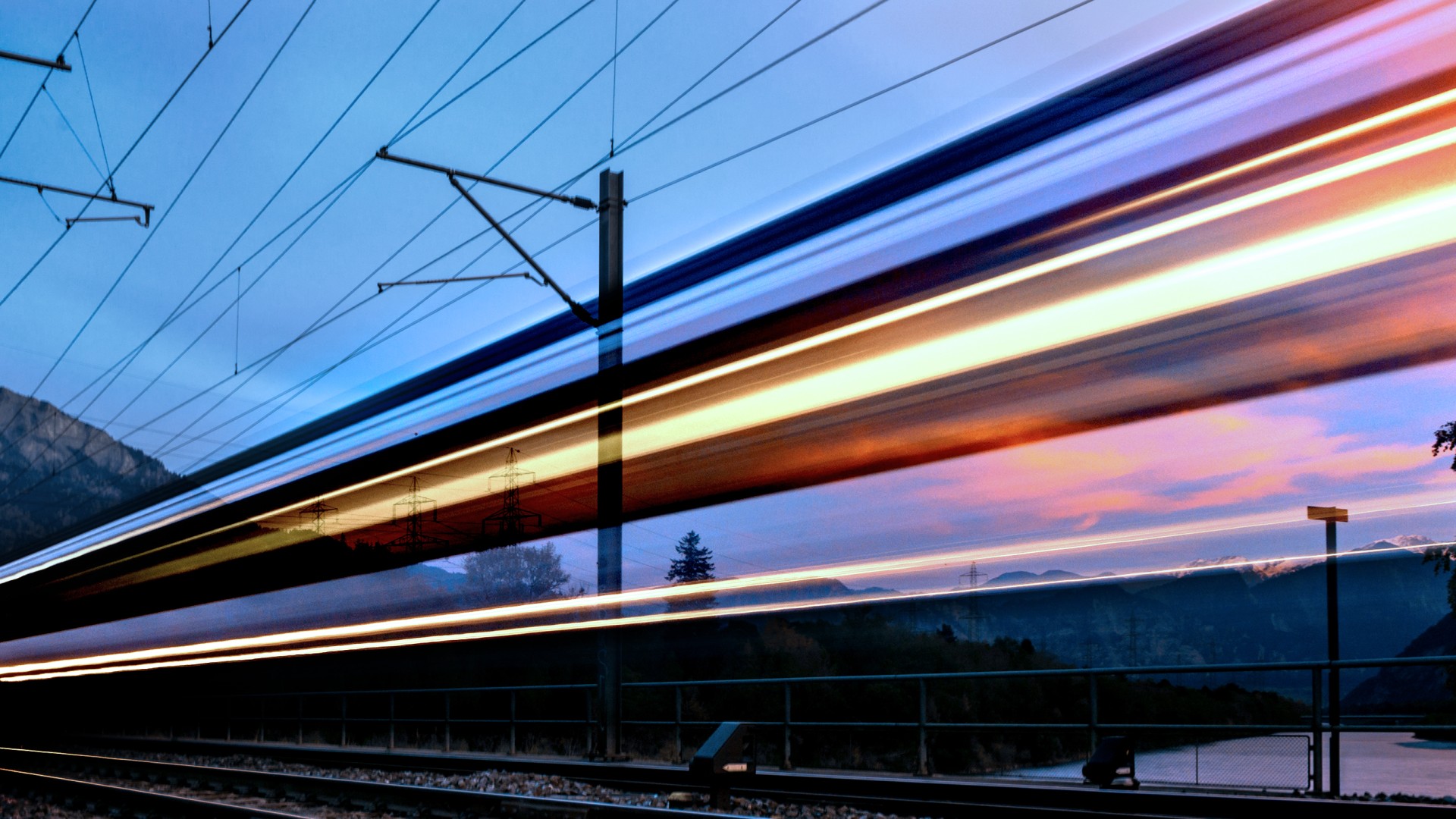 High-speed train passing through mountainous landscape at