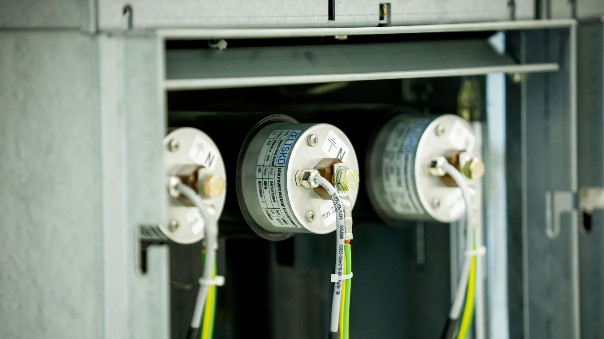 Electrical components inside a metallic control panel.