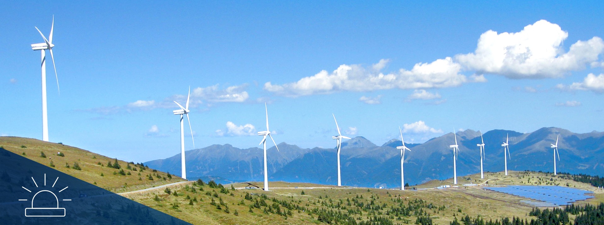 Wind turbines on a hillside with solar