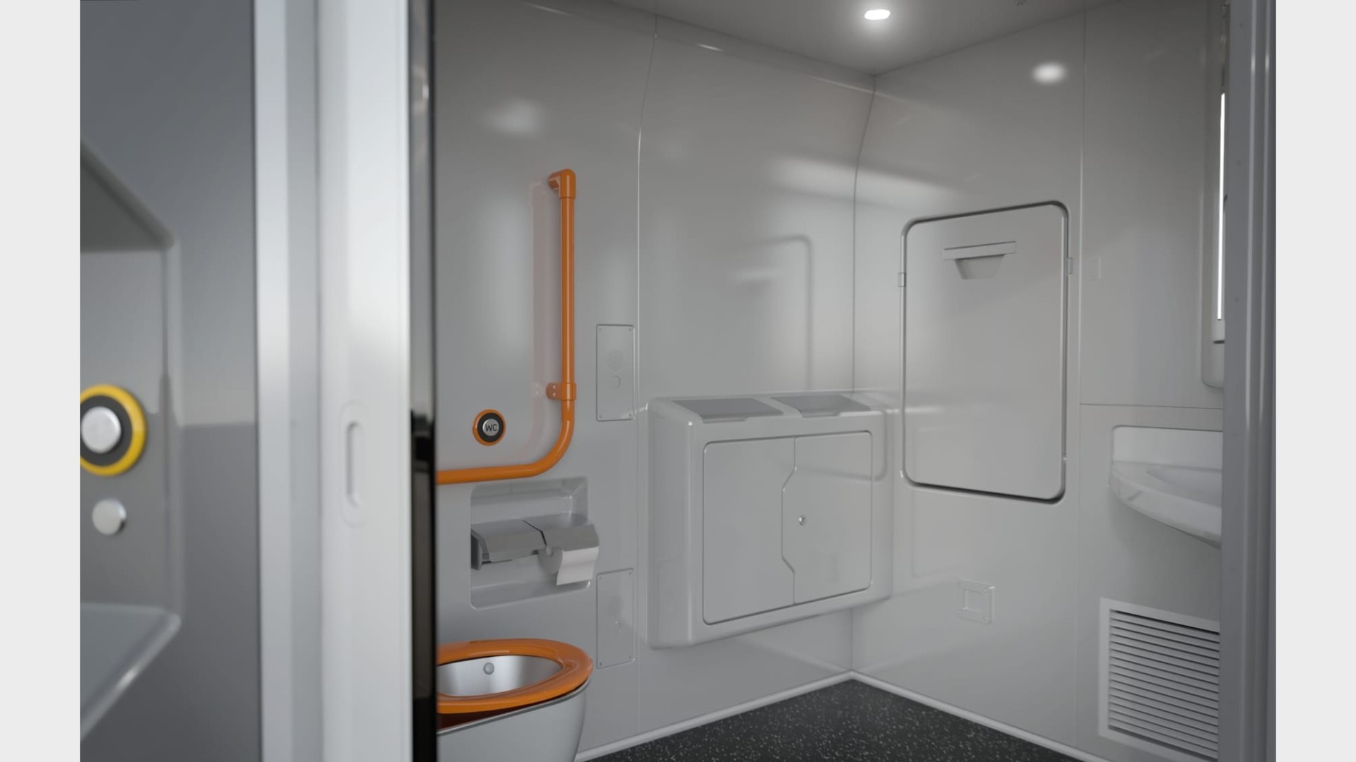 Interior of a grey train toilet cabin with door