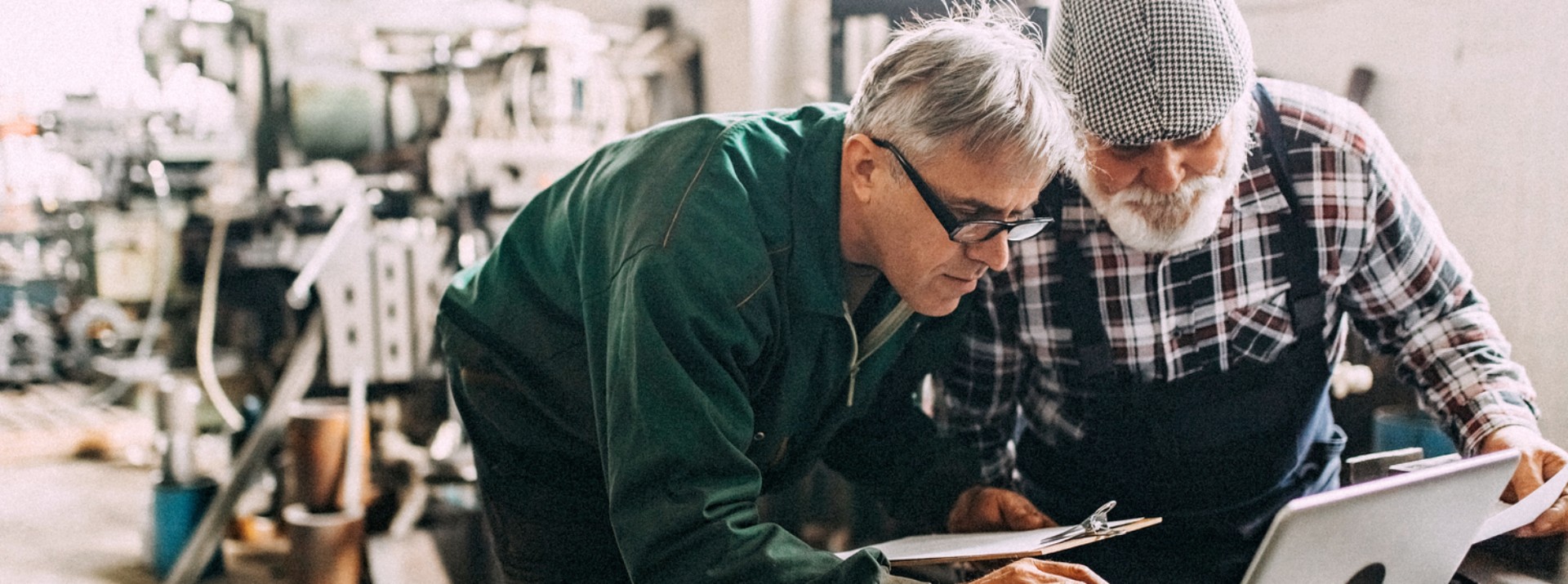 Two engineers discussing project on laptop in