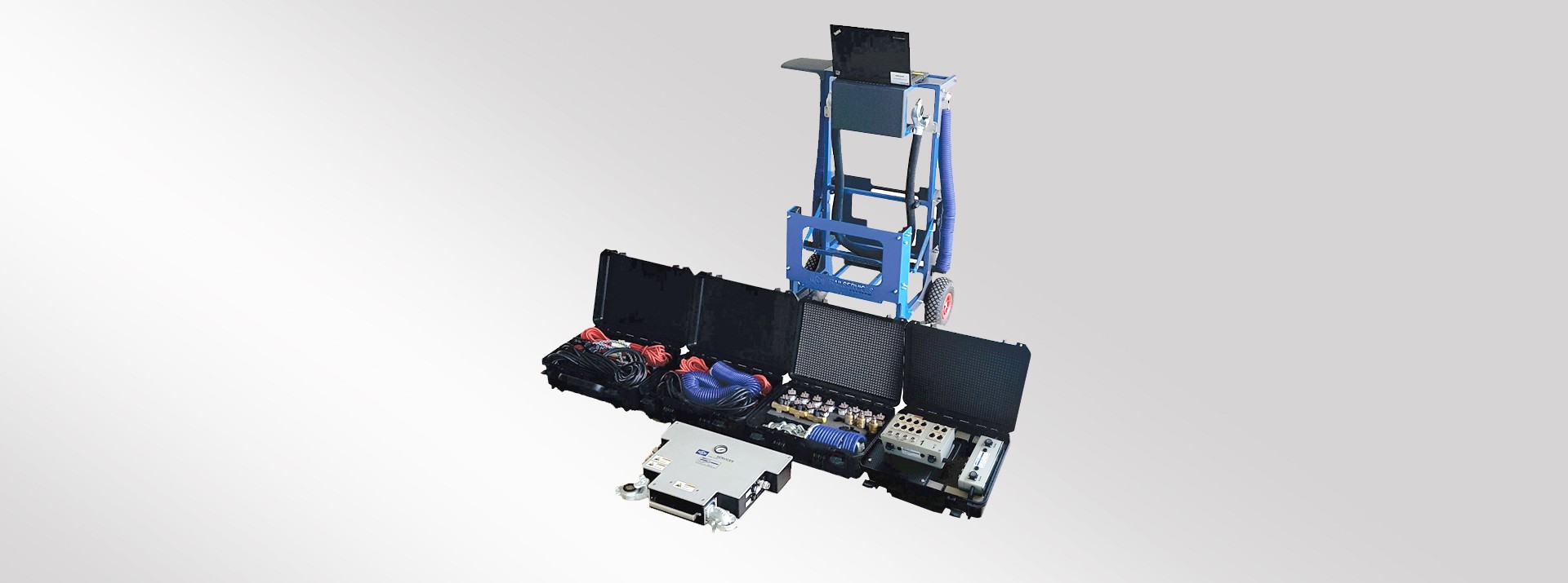 Portable testing equipment with multiple storage cases.