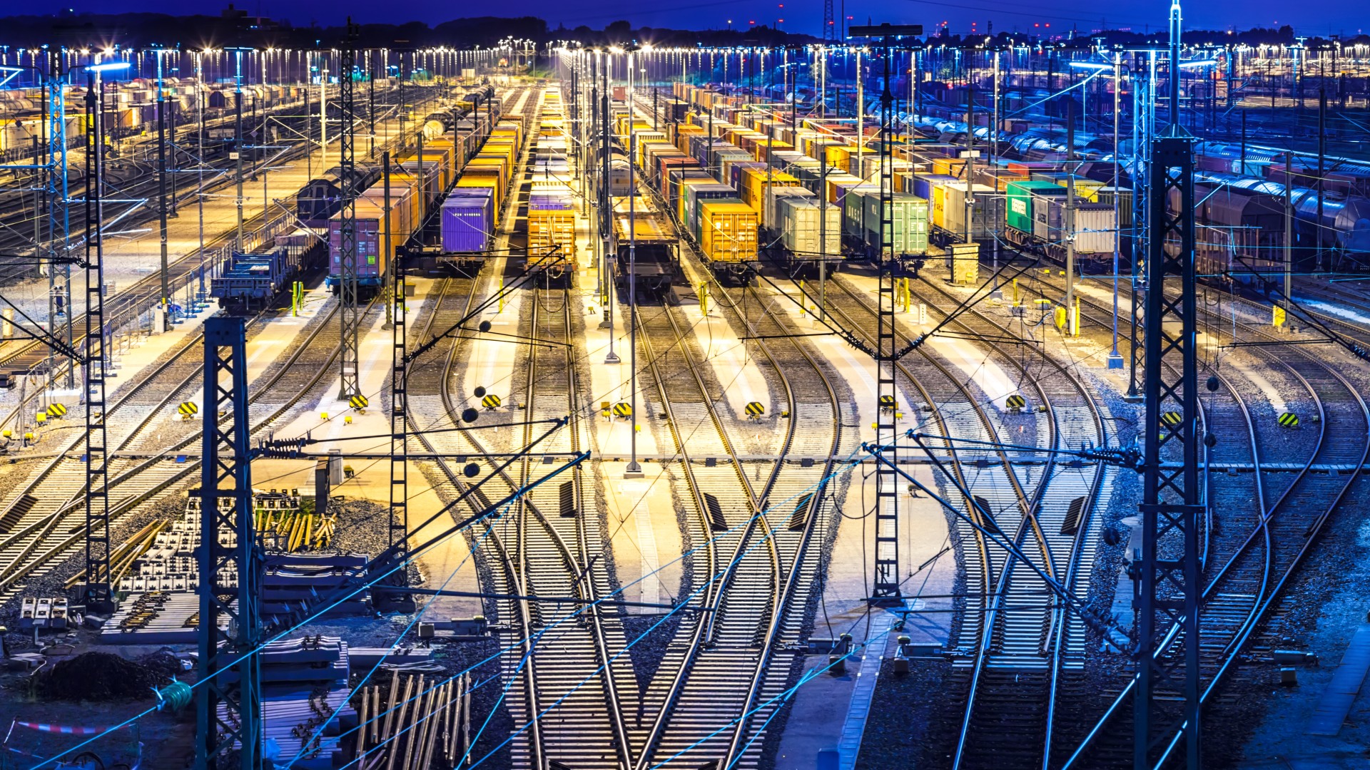 Nighttime view of illuminated freight yard.