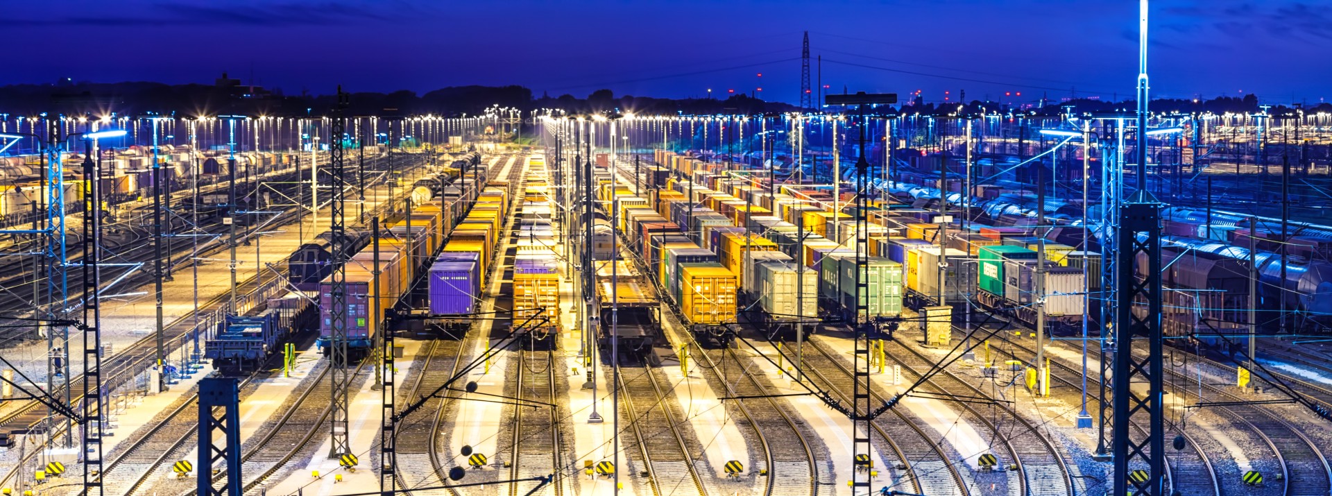 Nighttime view of illuminated freight yard.