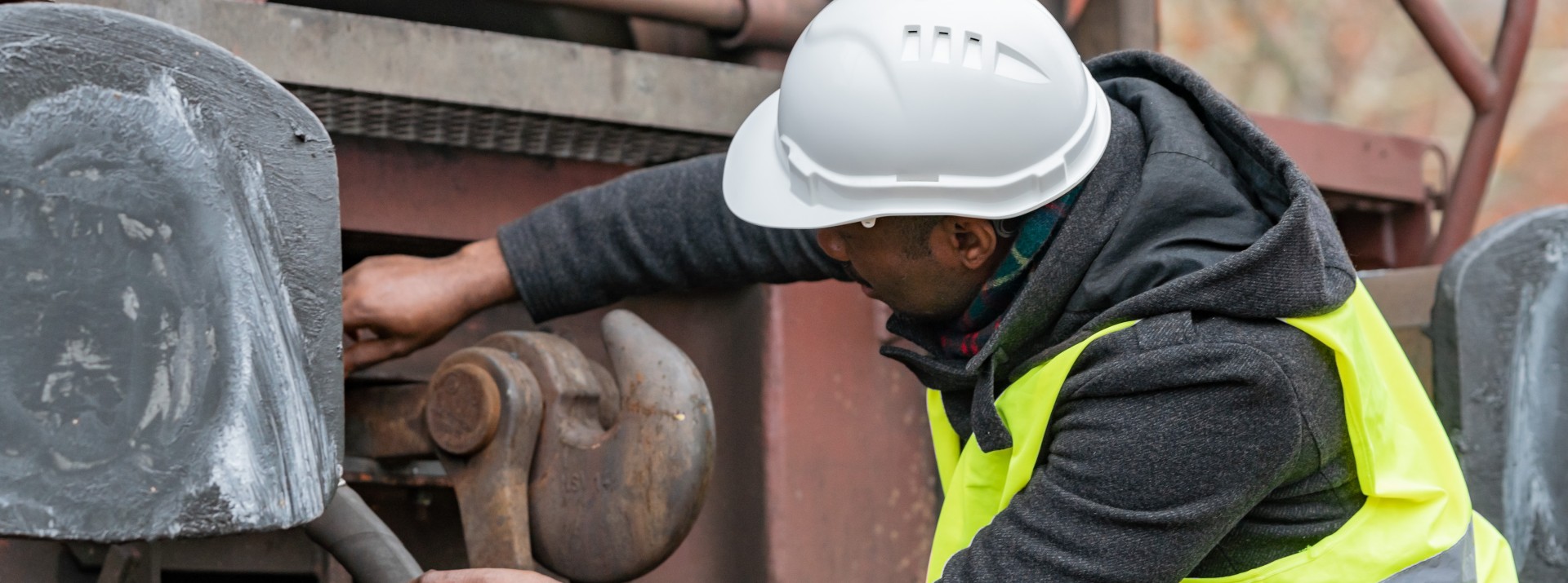 Rail worker and a manual coupler on a freight car