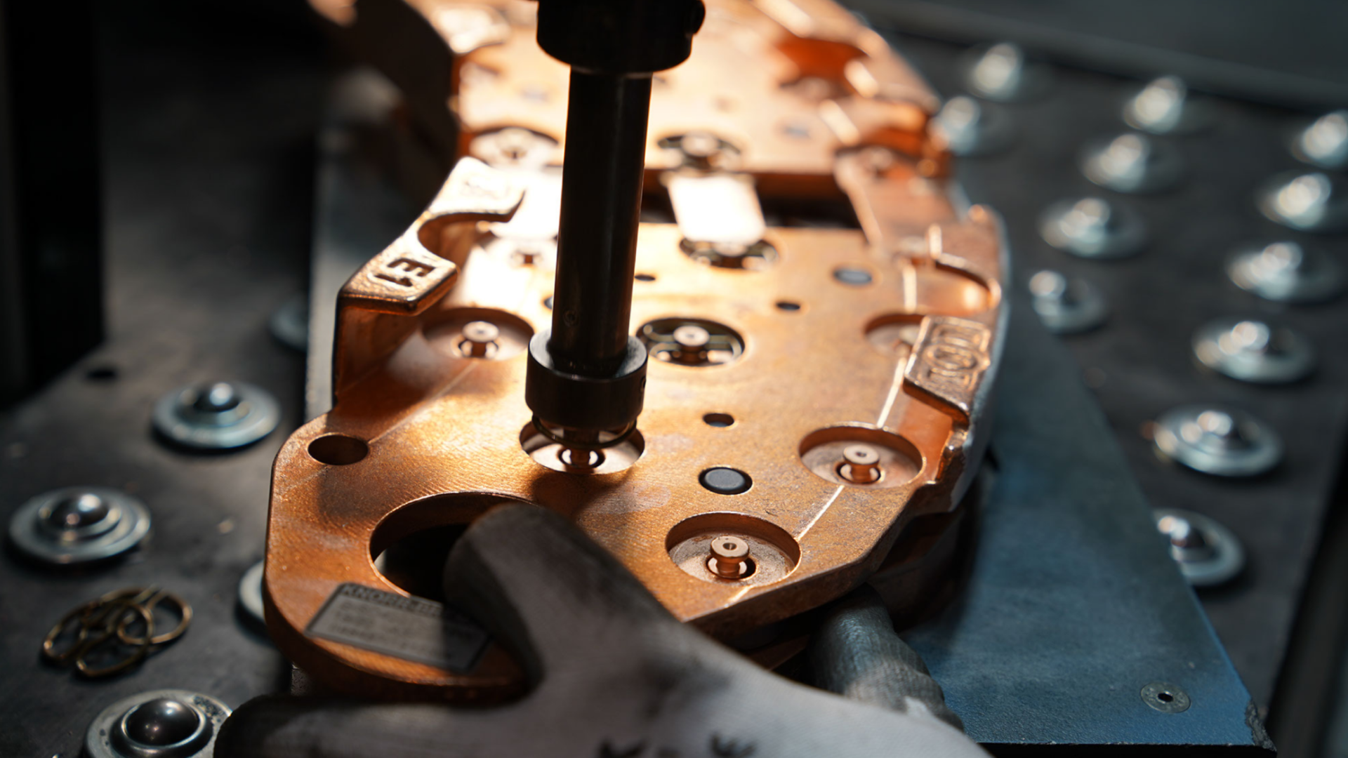 Copper component being assembled in manufacturing process.