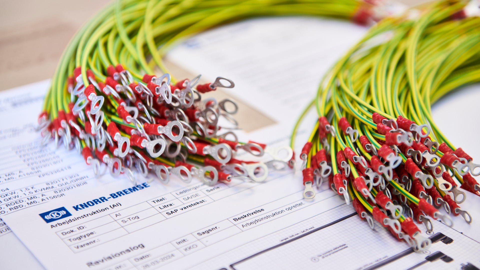Wires with connectors beside technical documentation sheets