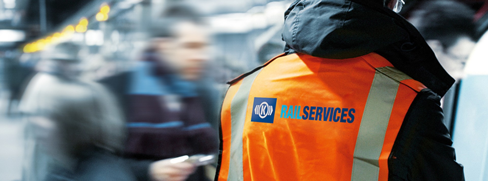 Rail services worker in high-visibility safety vest.