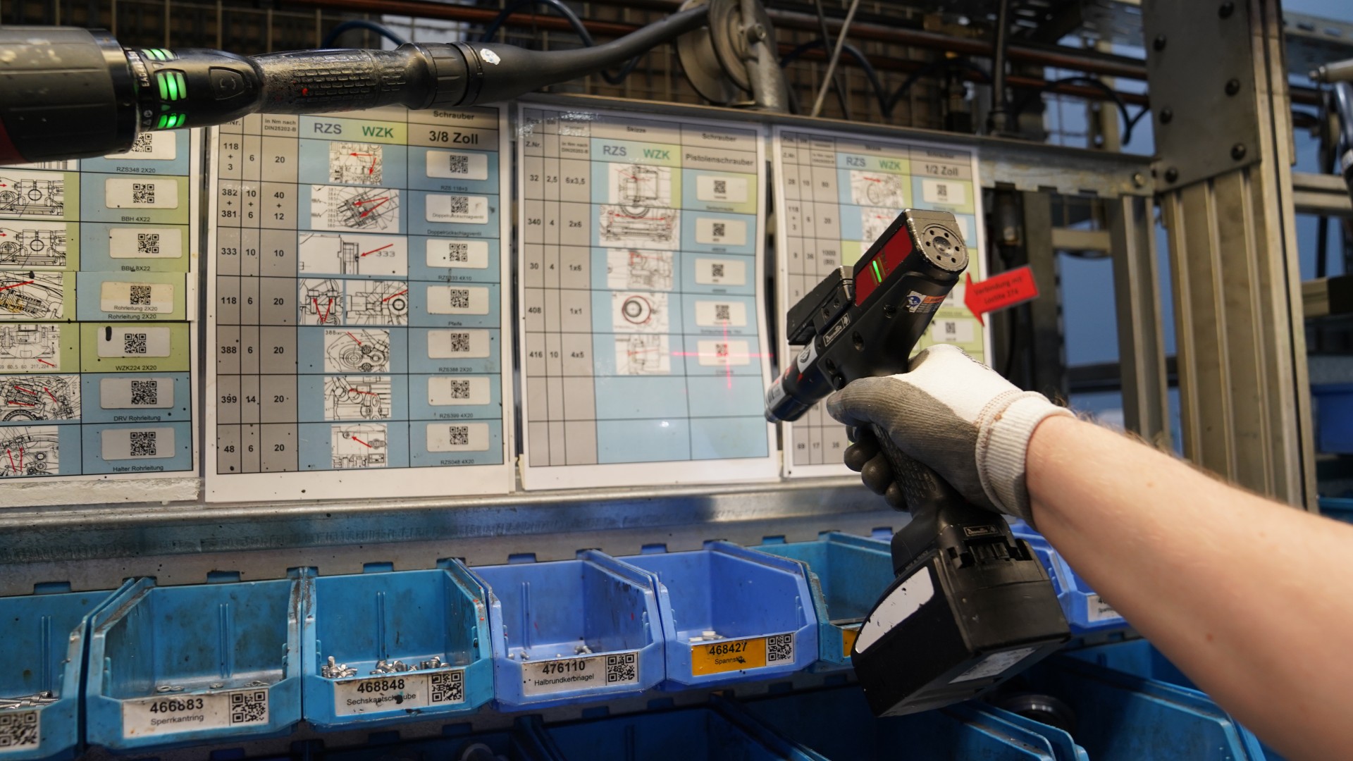 Worker scanning QR codes next to tool