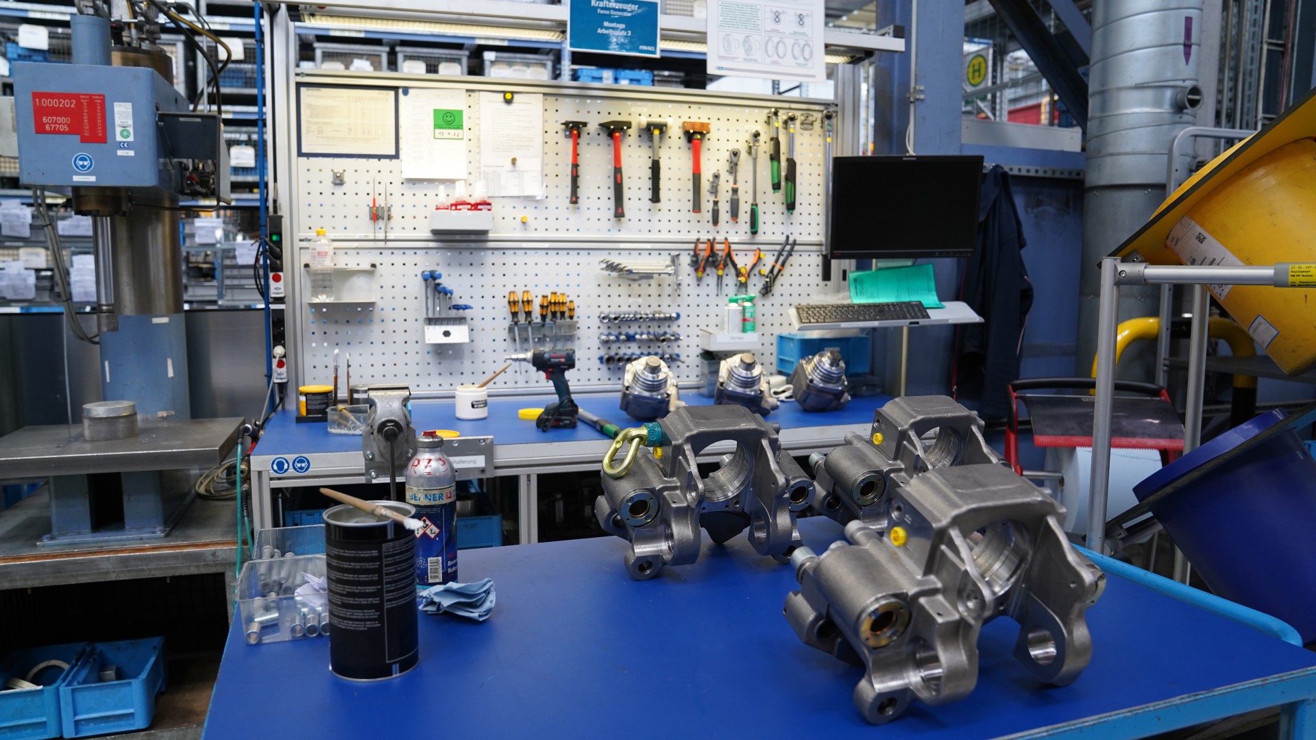 Manufacturing workspace with tools and mechanical components.