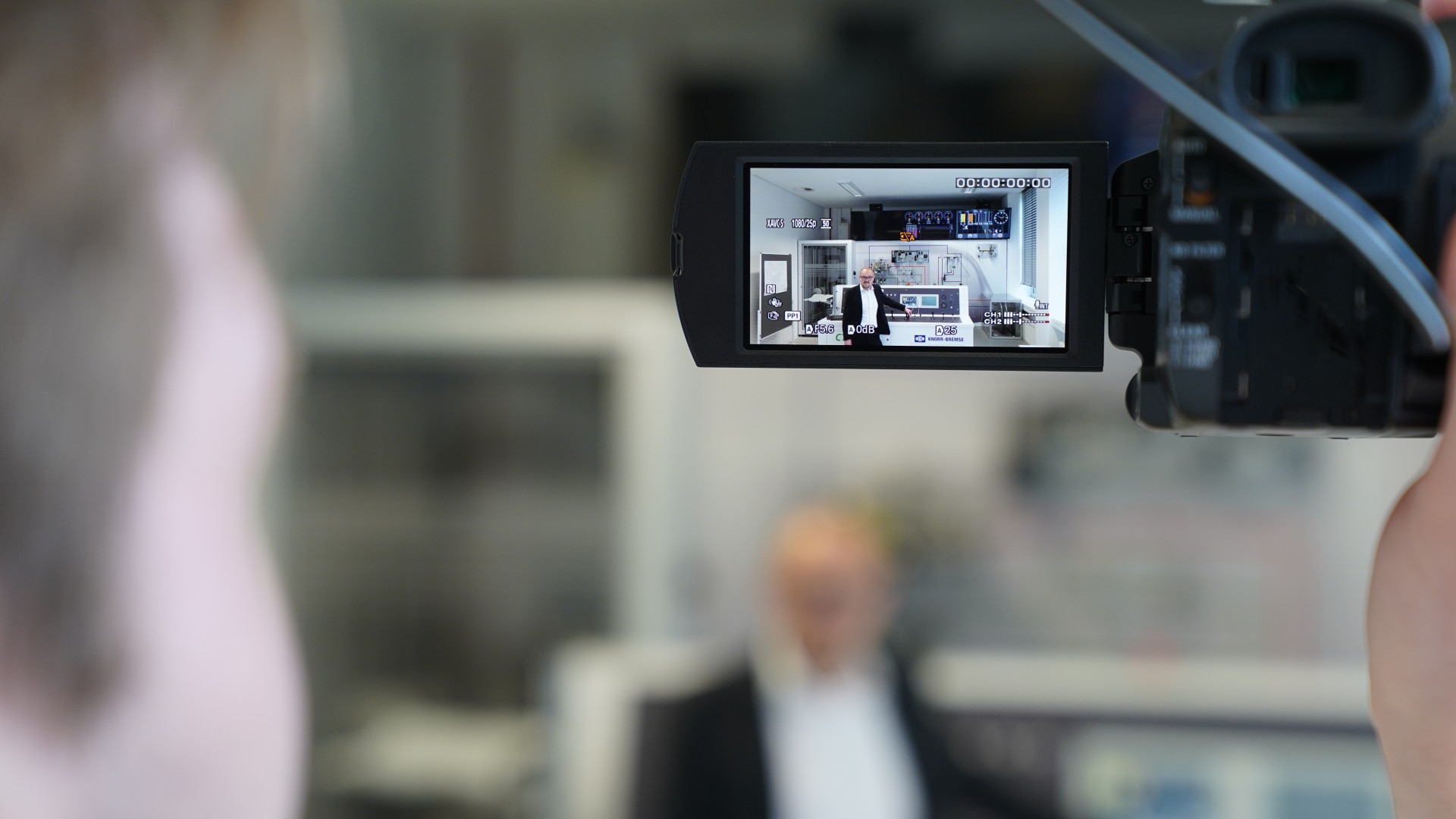 Video camera recording professional presentation indoors
