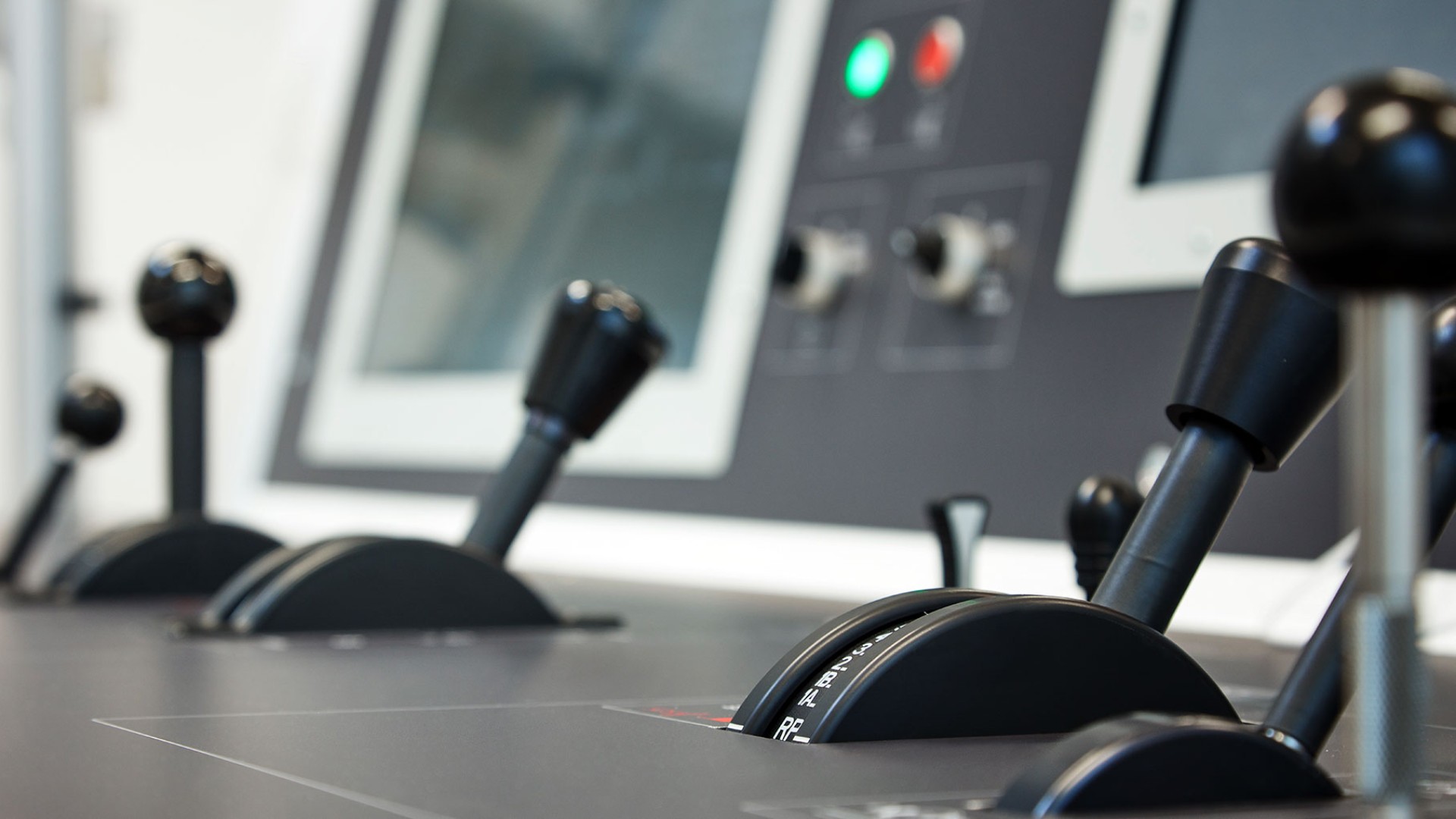 Control levers on an industrial console panel.