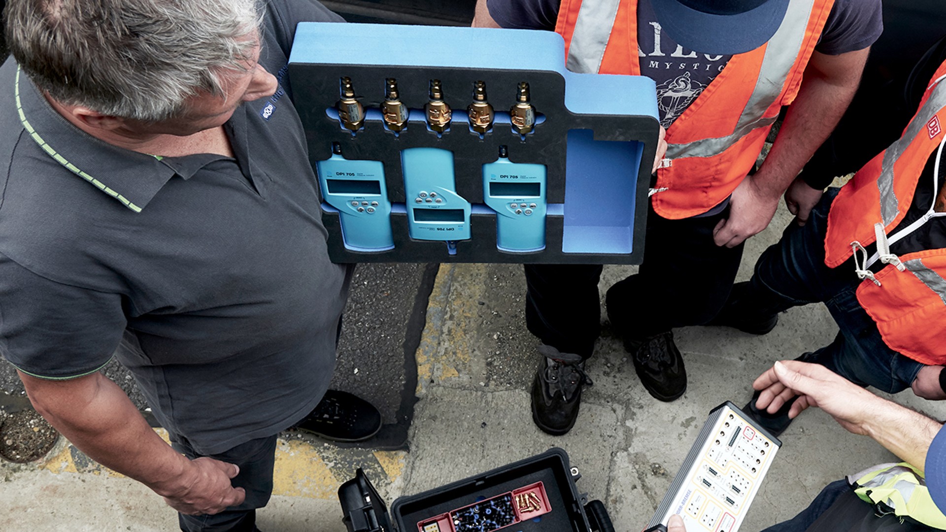 Technicians examining Knorr-Bremse diagnostic equipment.