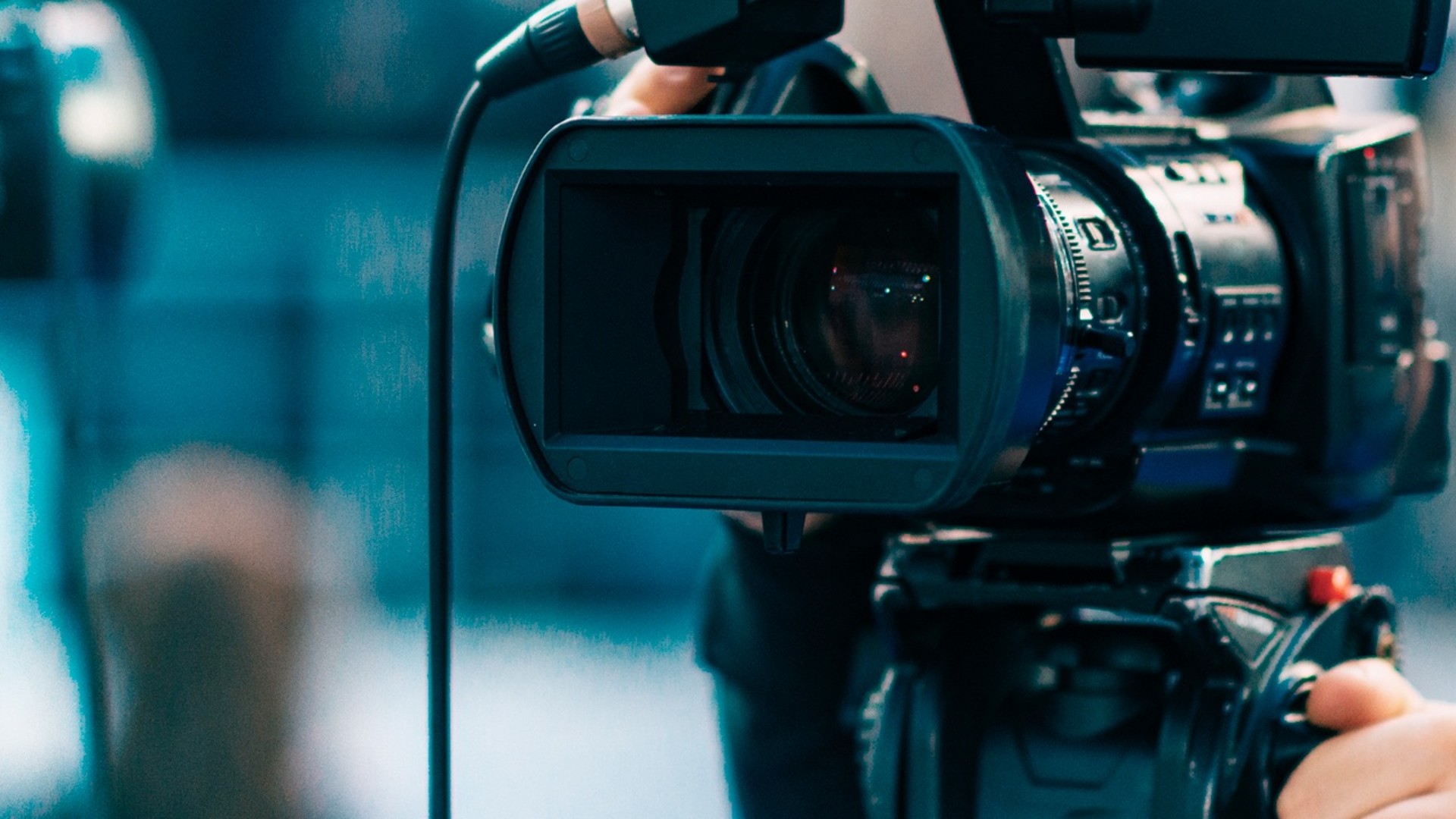 Camera in focus at a media event.