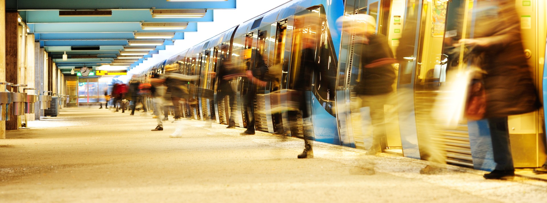 Busy train station platform with passengers boarding