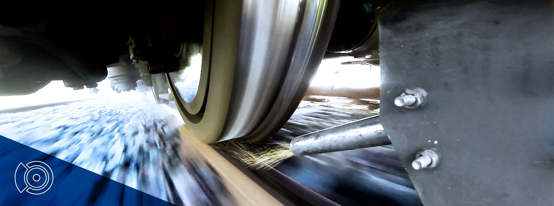 Train wheel in motion on railway tracks.