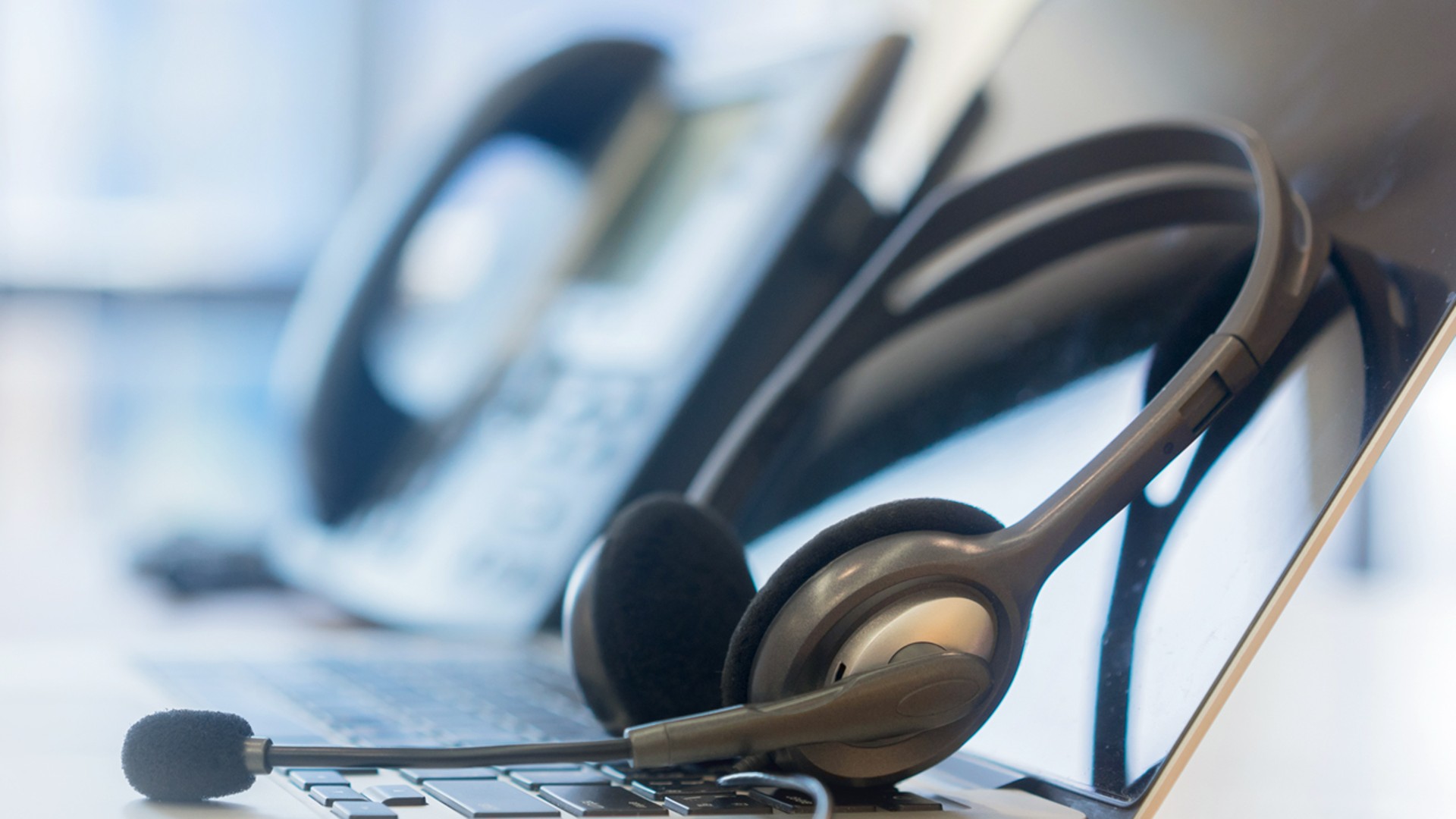 Headset placed on laptop keyboard in office