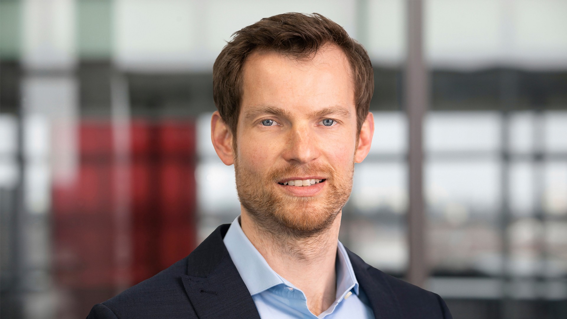 Smiling man in business attire, modern office