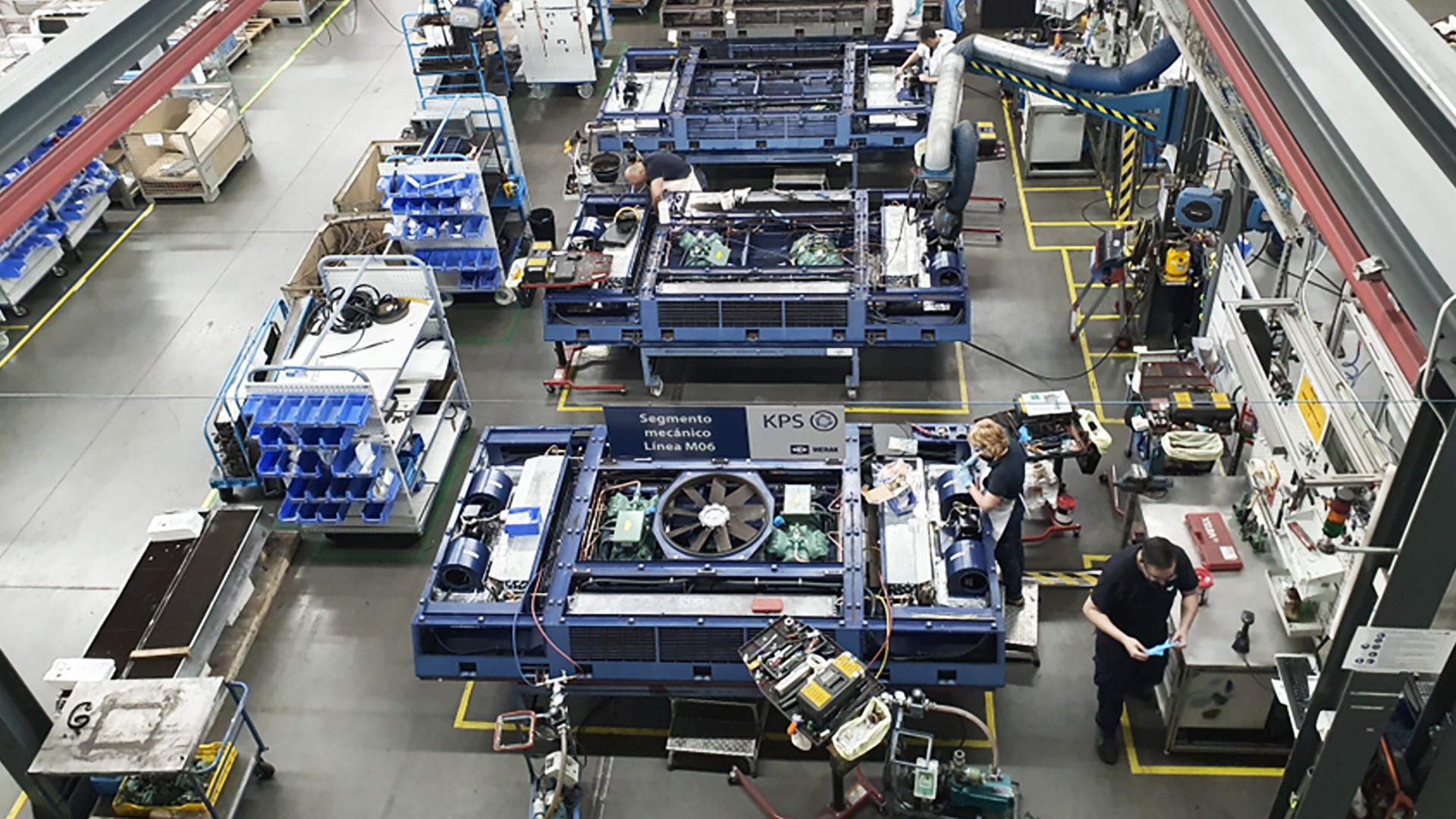 Manufacturing floor with assembly stations and employees
