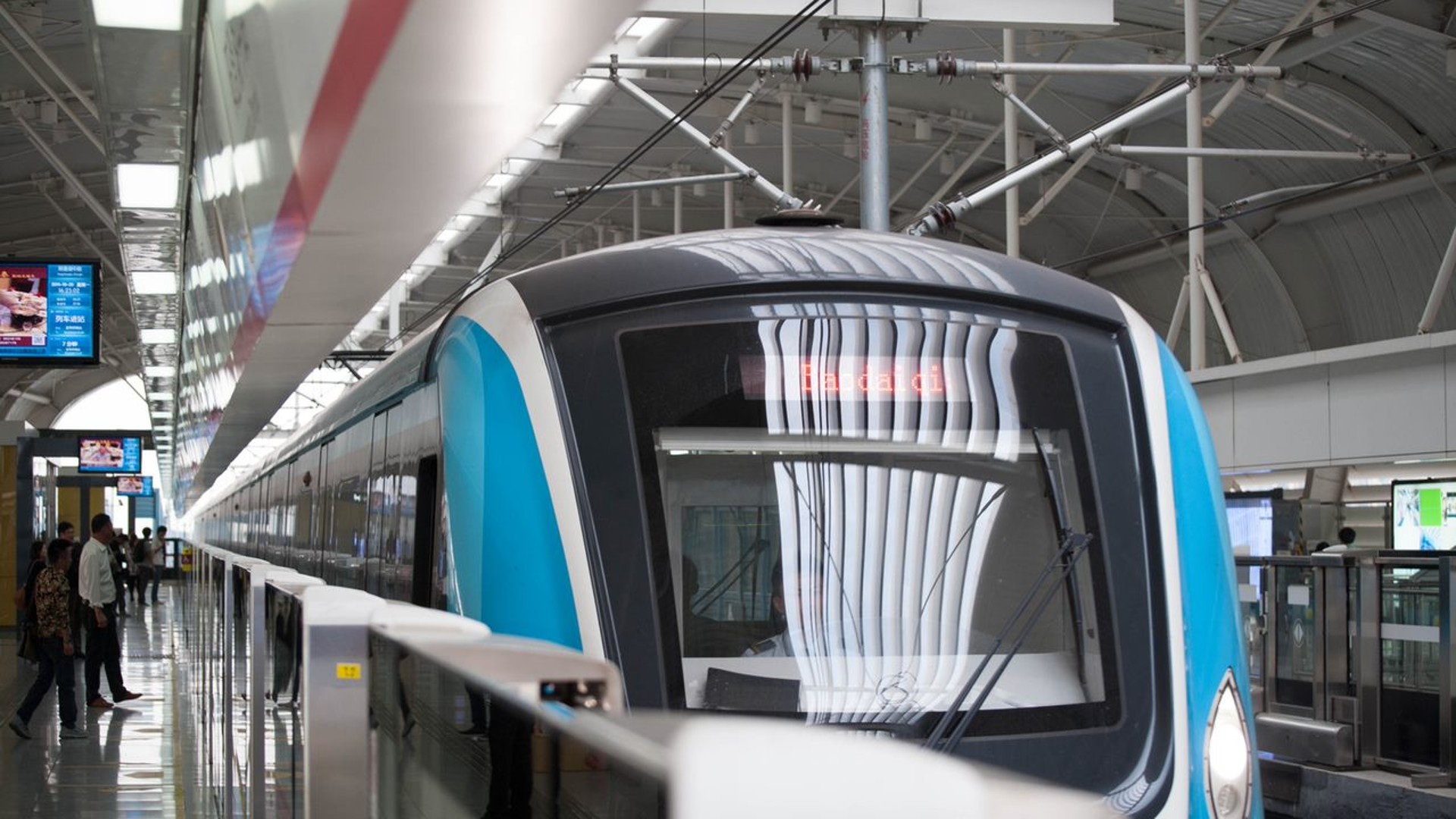 Modern train at a busy urban station