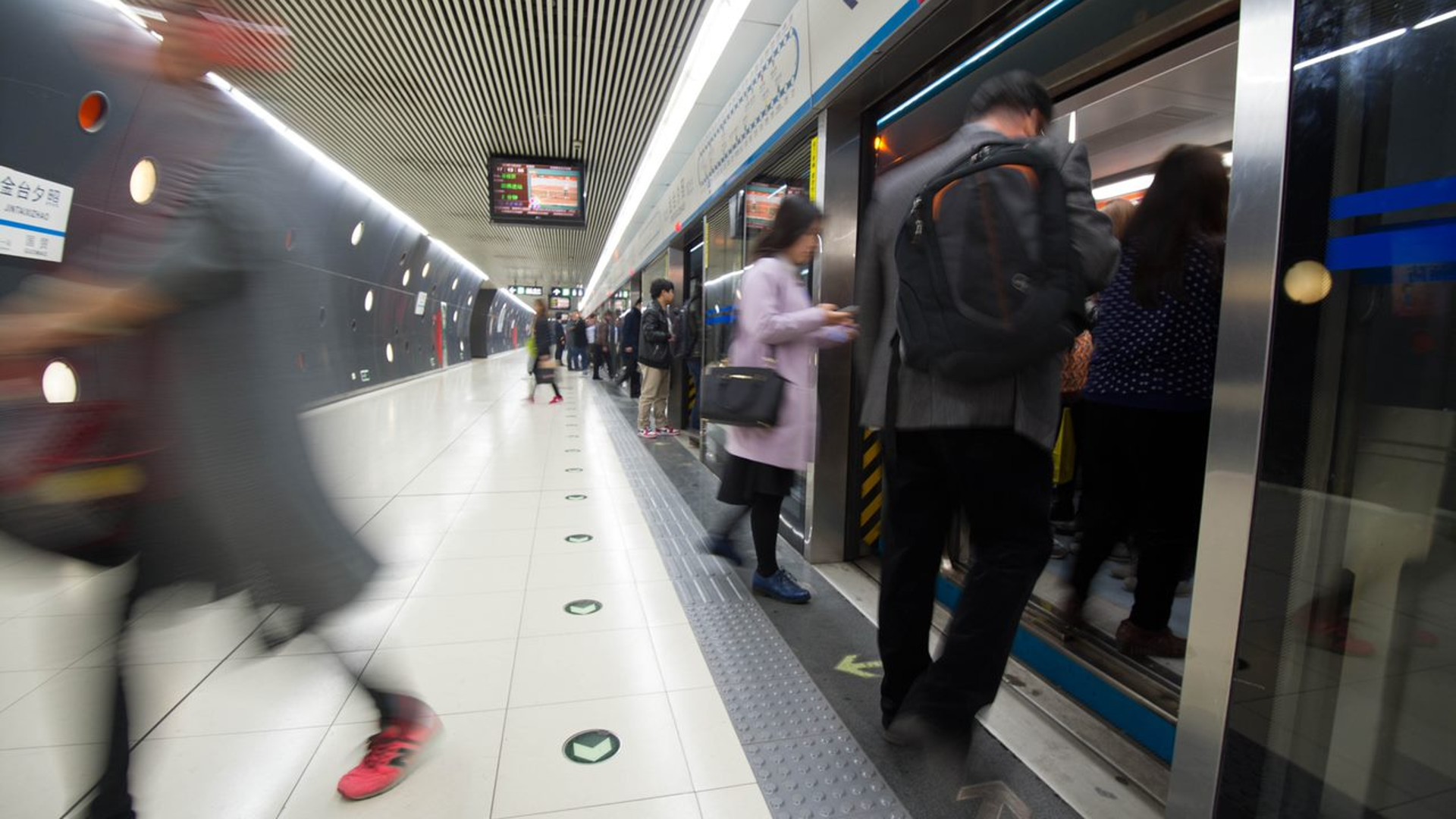 Crowded subway station with passengers boarding train