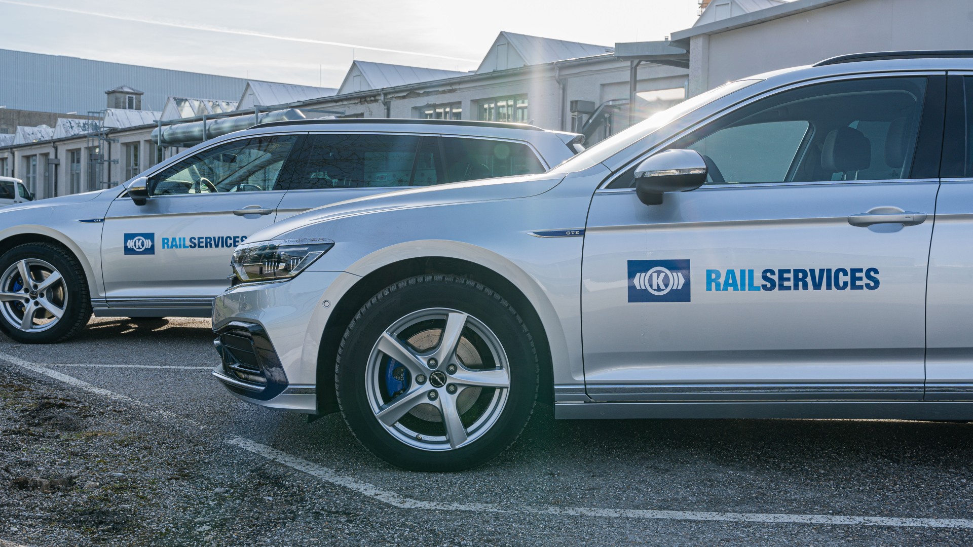 Silver vehicles with 'RAILSERVICES' branding parked outside.