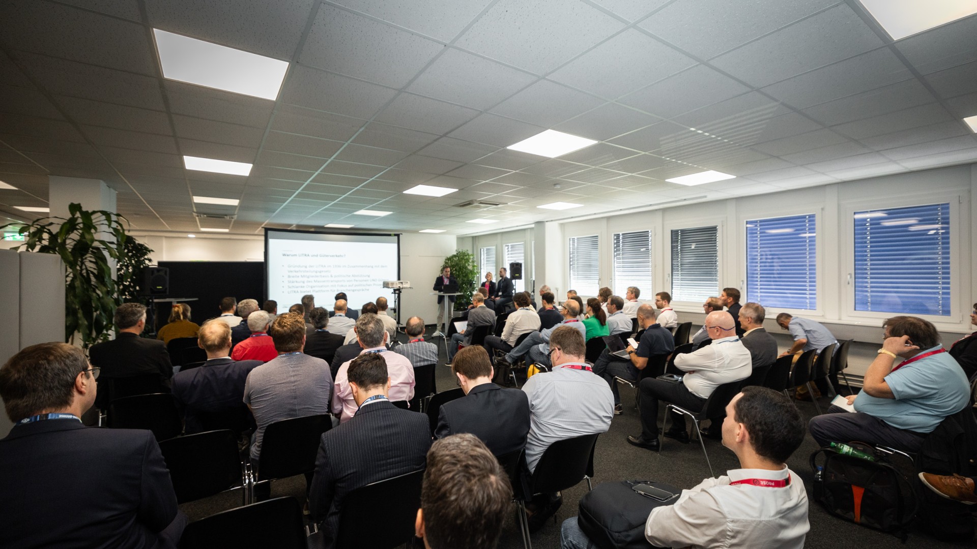 Professional audience attending a business presentation.