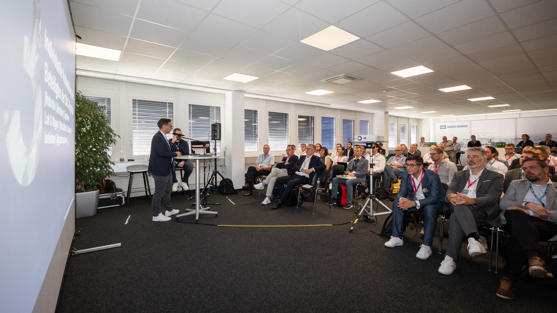 Business presentation with audience in conference room.