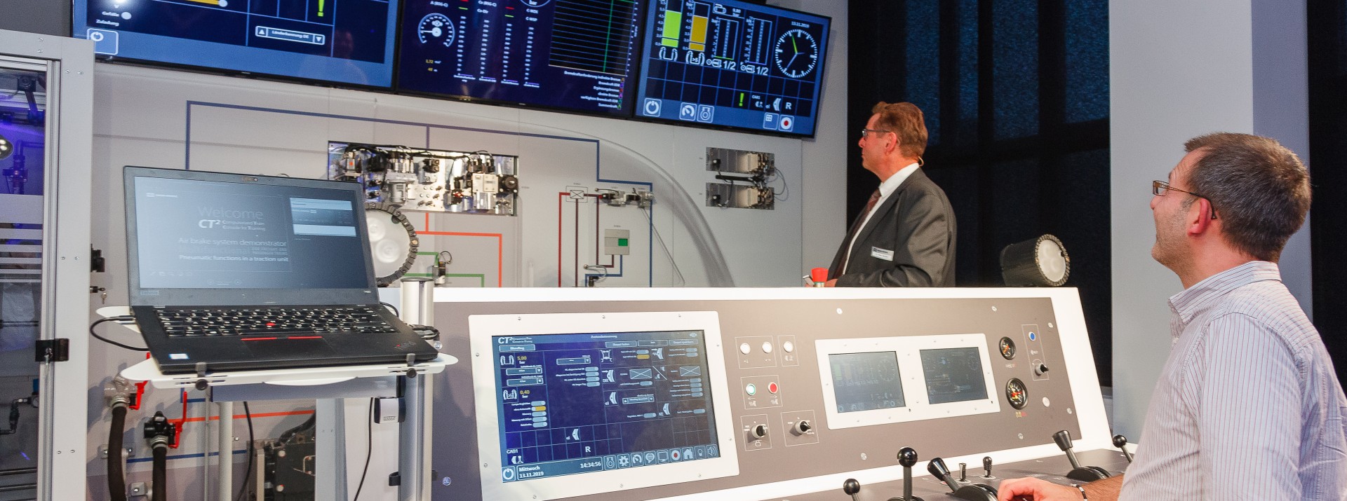 Train control room with monitors and operators.