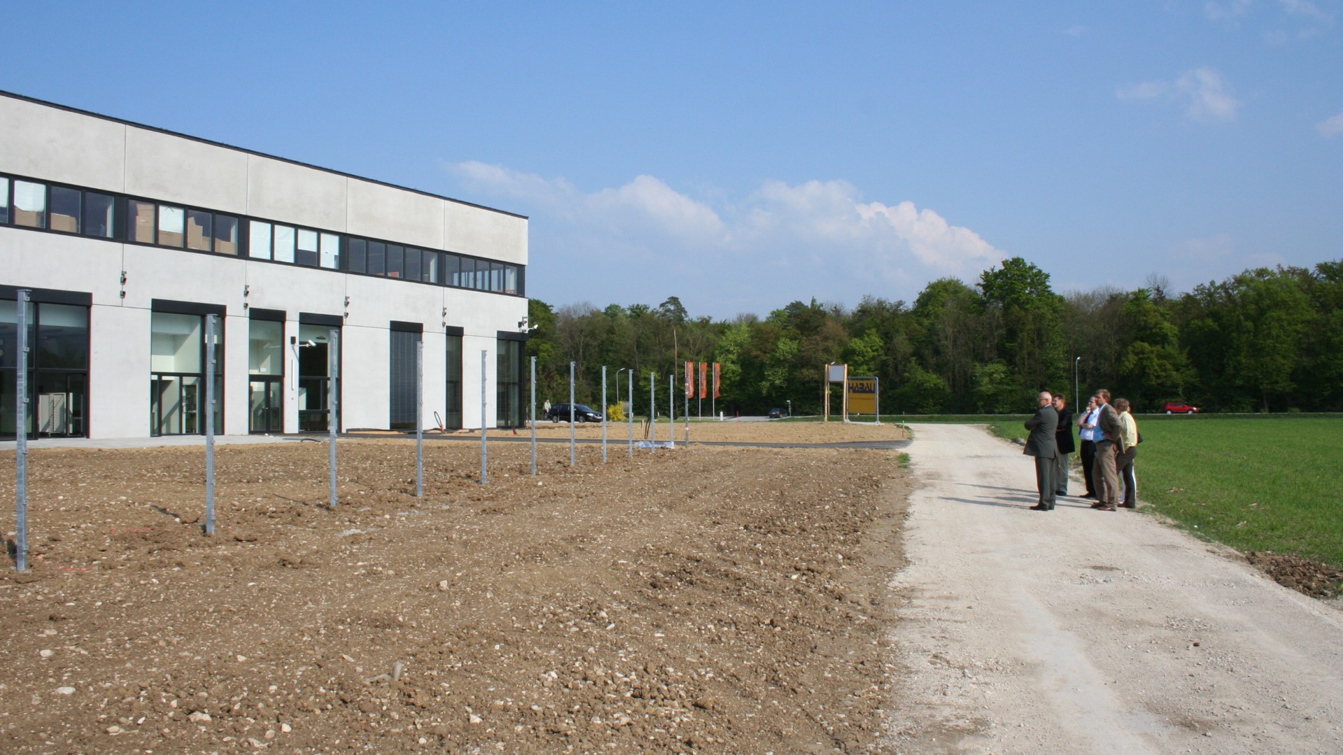 Construction site with modern building and employees.