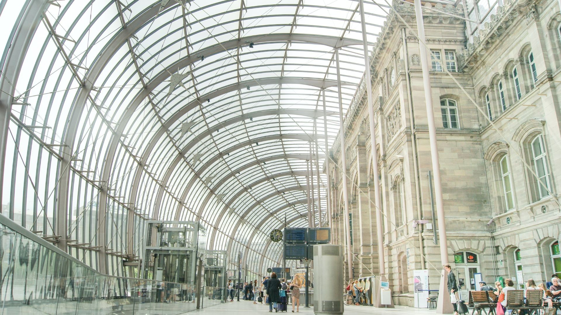 Modern train station interior with glass roof