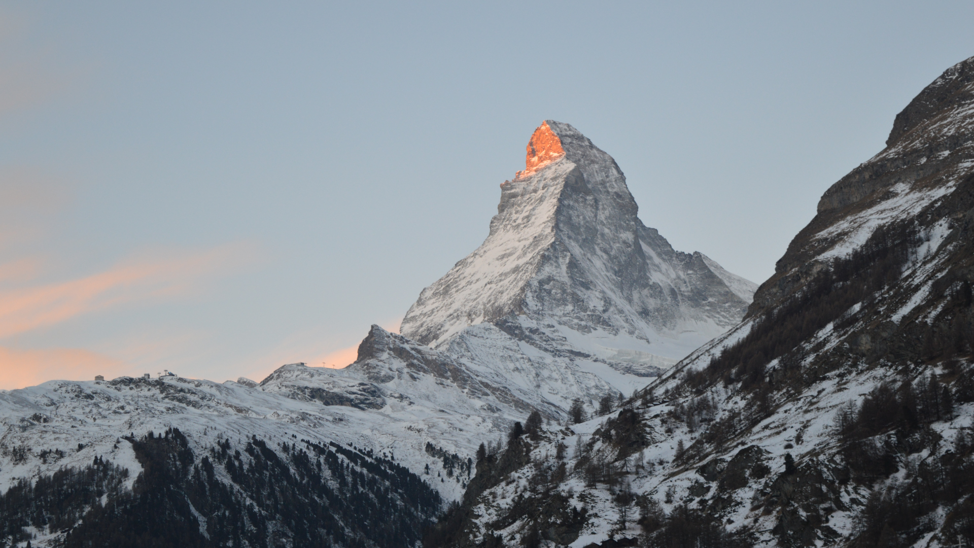Matterhorn mountain peak at sunset with snow.