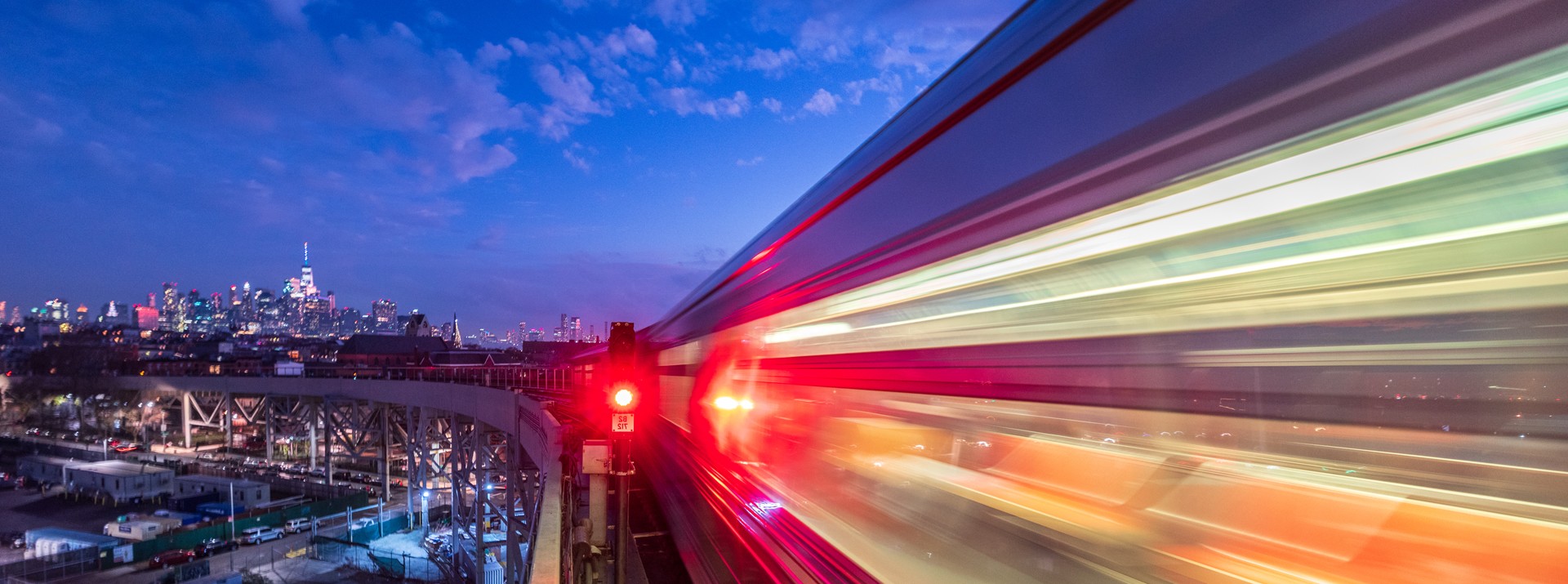 "Motion blur of train against city skyline"