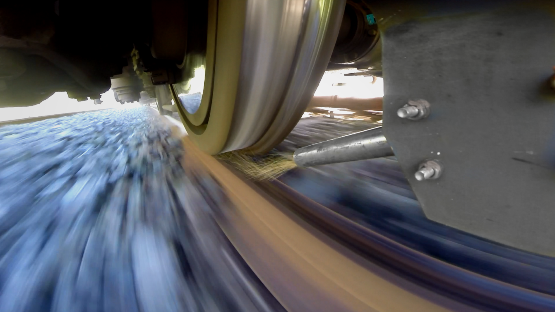 Train wheel approaching track at high speed.