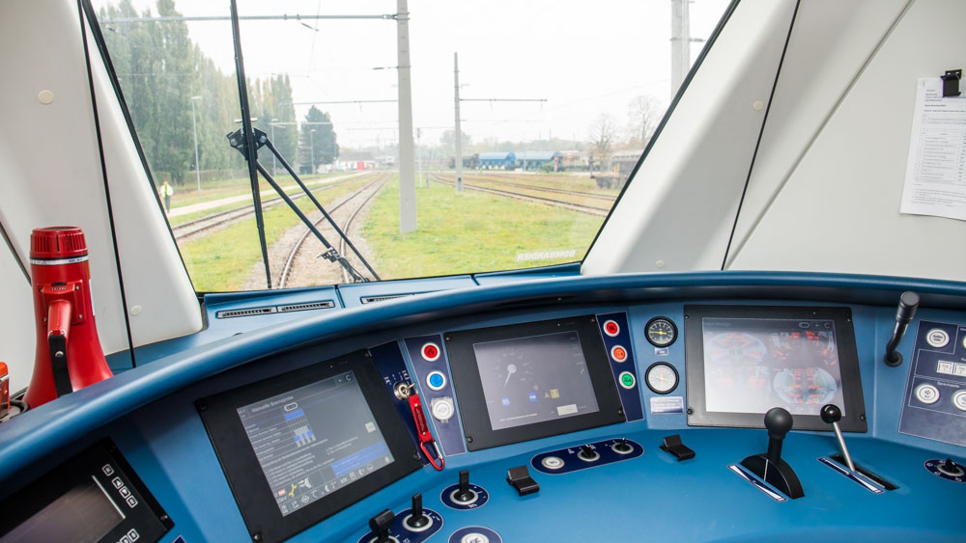 Train control dashboard with multiple digital displays.