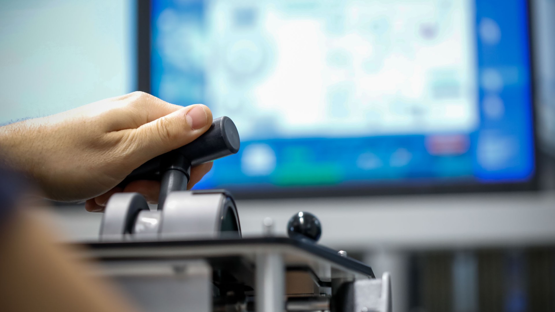 Hand operating control joystick with computer monitor